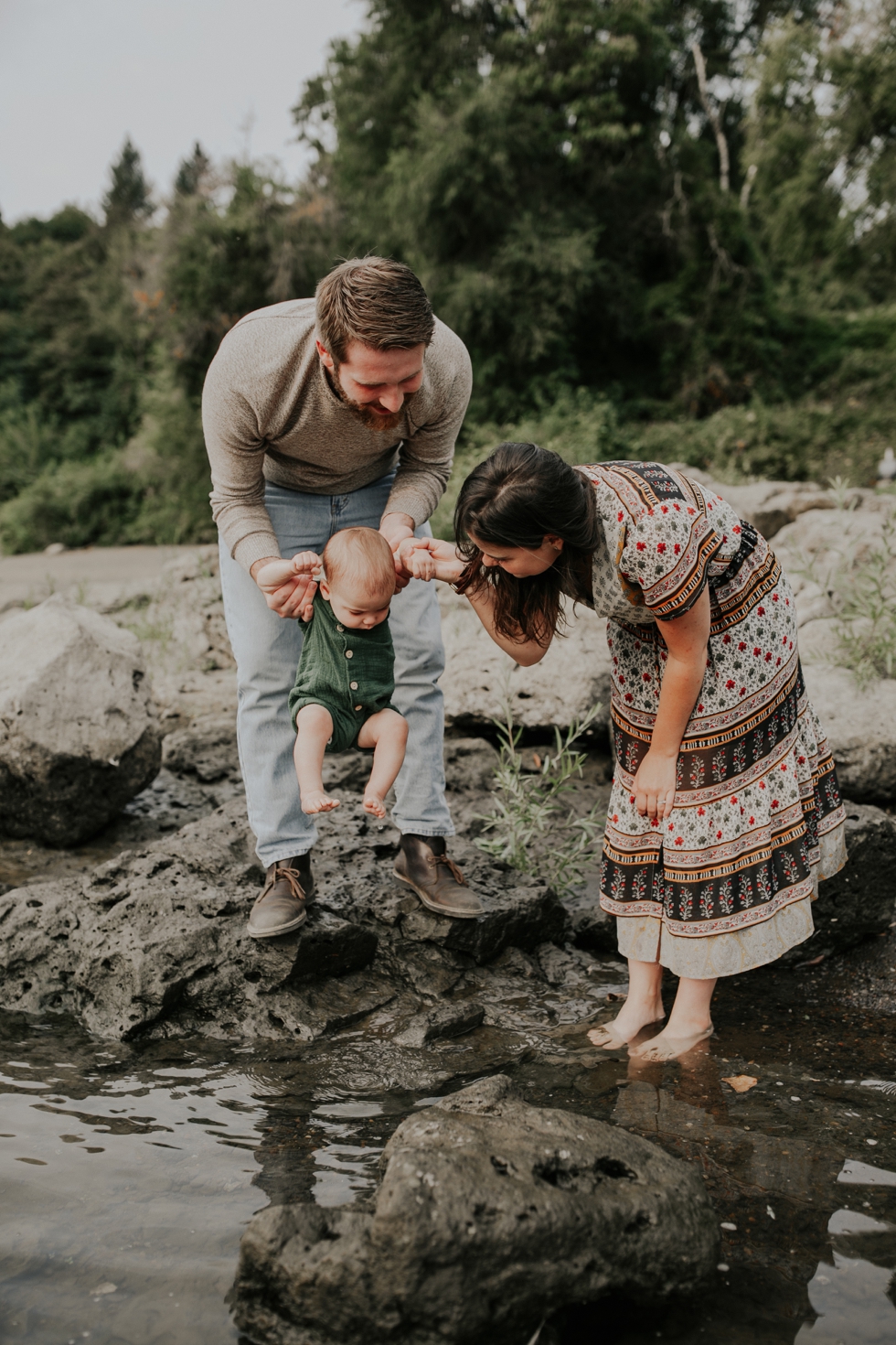 Mom and Dad dipping baby's toes in the water